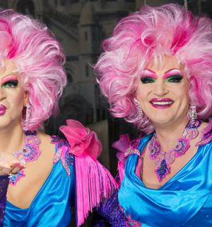 two women with pink hair standing next to each other