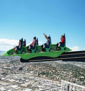 a group of people riding on a green airplane in the sky