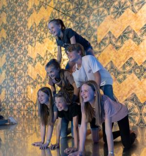 a group of people standing in front of a wall