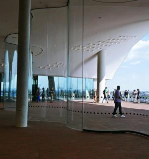 a group of people walking around a building