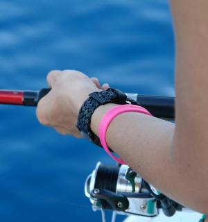 a persons hand holding a tennis racket