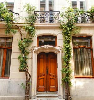 a building with a wooden door and ivy