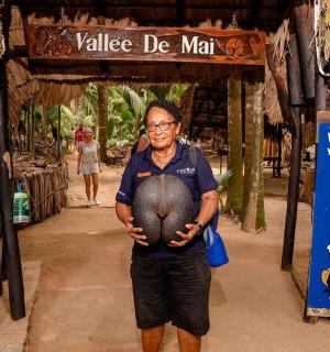 a man standing in front of a sign with a ball