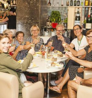 a group of people sitting around a table in a restaurant