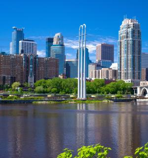 a city skyline with a bridge over a river