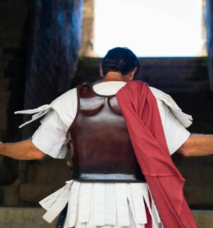 a man in a costume standing with his arms outstretched