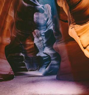 a person is standing in a slot canyon