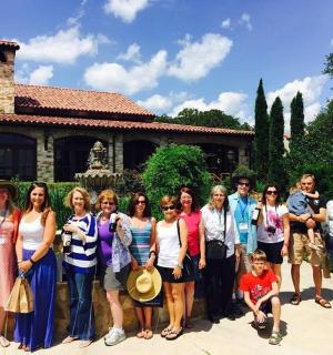 a group of people posing for a picture in front of a house