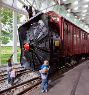 a group of children are looking at a train