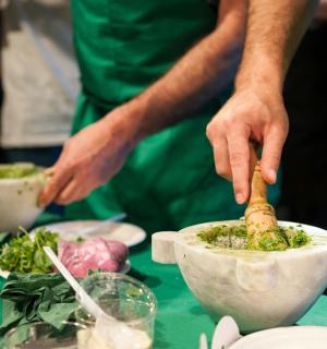 a person preparing food in a bowl on a table