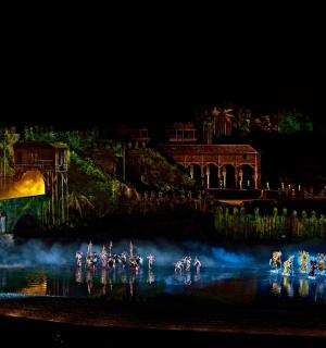 a group of people on bikes in the water at night
