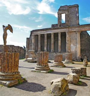 a statue of a man and a dolphin in front of a building