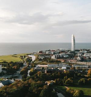 an aerial view of a city with a tall tower