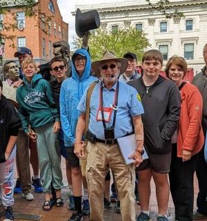 a group of people posing for a picture on a street