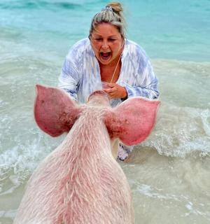 a woman in the water with a horse in the water