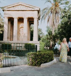 a man and a woman standing in front of a building