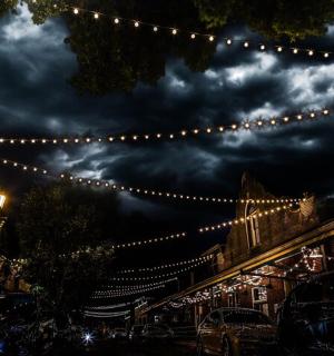 a string of lights hanging over a street at night