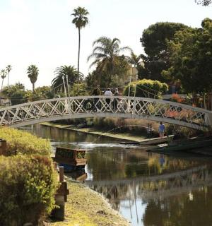 a bridge over a river with people walking on it