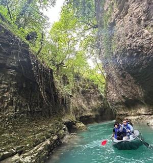 a group of people in a boat in a river