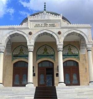 a large building with two doors and stairs in front