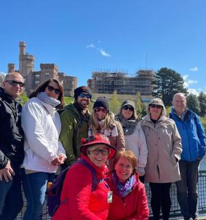 a group of people posing for a picture on a bridge
