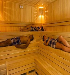 a couple of people laying in a sauna
