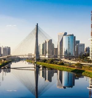 a bridge over a river in front of a city