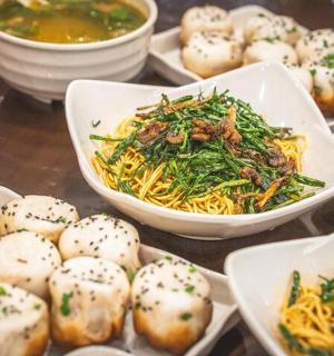 a table with plates of food and bowls of food