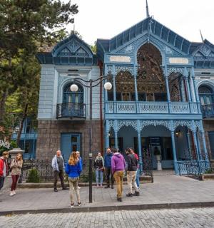 a group of people walking in front of a building