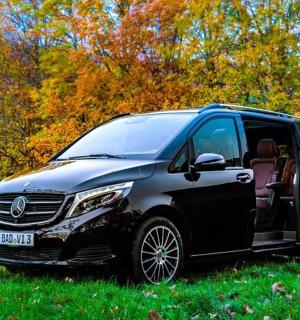 a silver and black van parked in a field