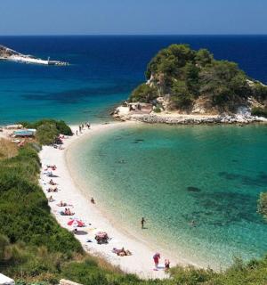 a beach with a group of people in the water