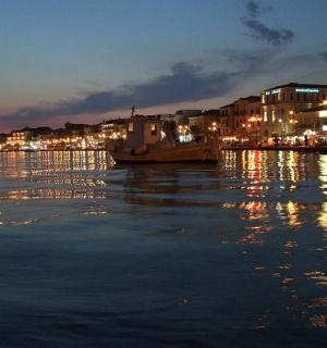 a boat is docked on a river at night