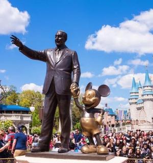 a statue of a man in front of walt disney world