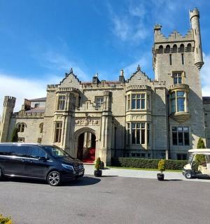 a van parked in front of a building with a golf cart