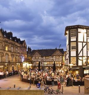 a crowd of people in a city with buildings