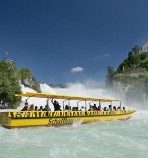 a group of people riding a yellow boat on the water