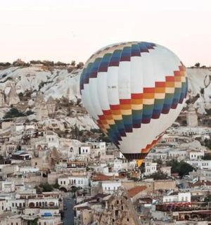 a group of hot air balloons flying over a city