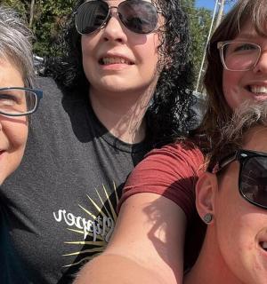 a group of four women posing for a picture