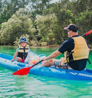 a man and a woman in a kayak on the water