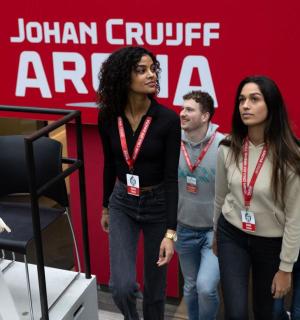 一群人站在一堵红墙前