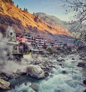 a river with a town on the side of a mountain