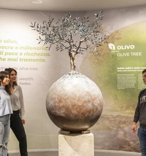 a group of people looking at a vase in a museum