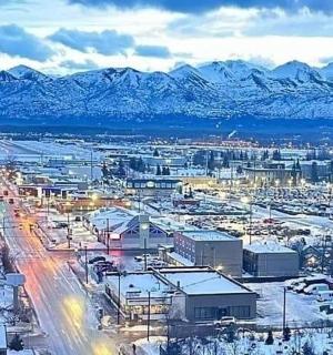 a city with snow covered mountains in the background