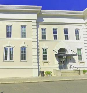 a white building with a staircase in front of it