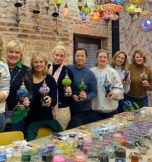 a group of women standing in front of a table