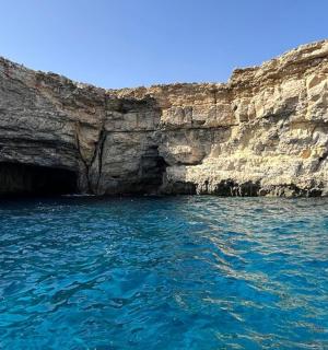 a large pool of water next to a cliff