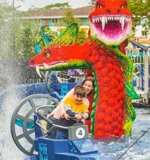 a woman and a child on a water ride at a water park