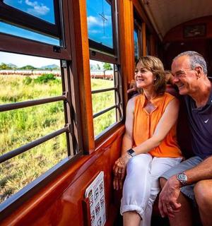 a man and a woman sitting on a train