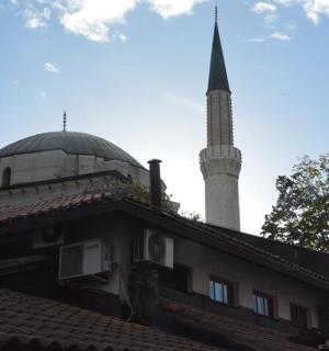 a mosque with a minaret on top of a building