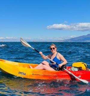 a woman sitting in a kayak in the ocean